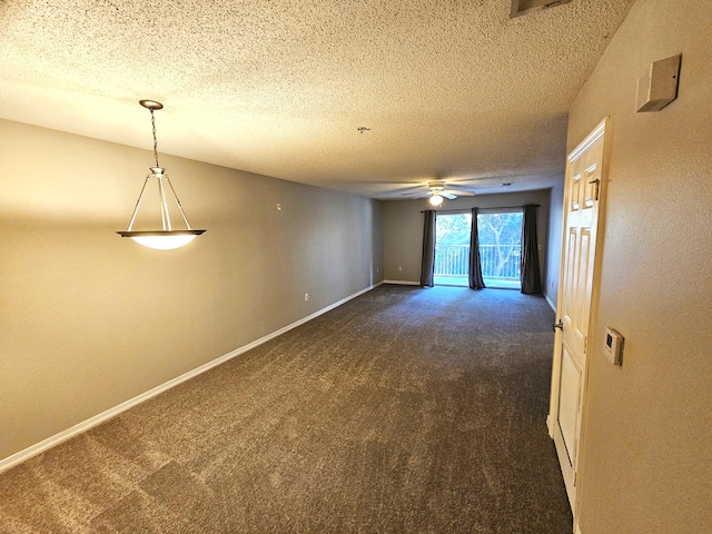 carpeted empty room with ceiling fan and a textured ceiling