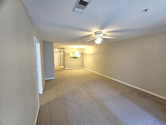 carpeted empty room with a textured ceiling and ceiling fan