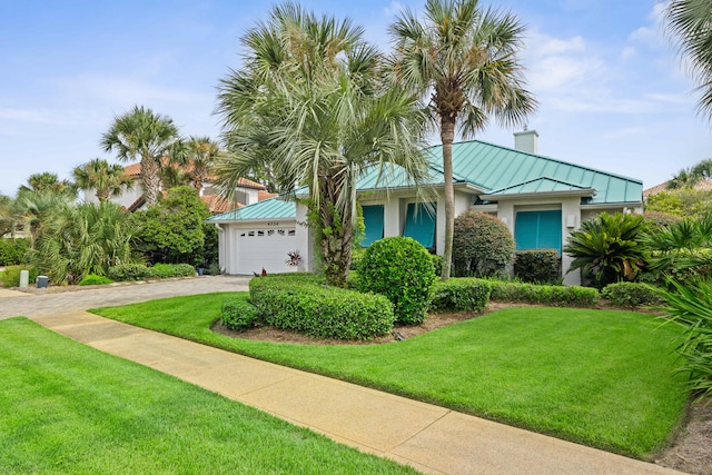 view of front of home with a garage and a front yard