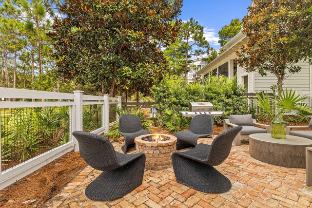 view of patio with a grill and a fire pit