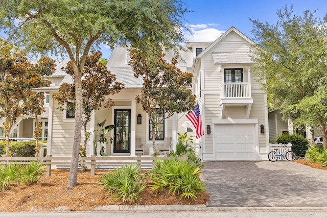 view of front of property featuring a garage and a balcony