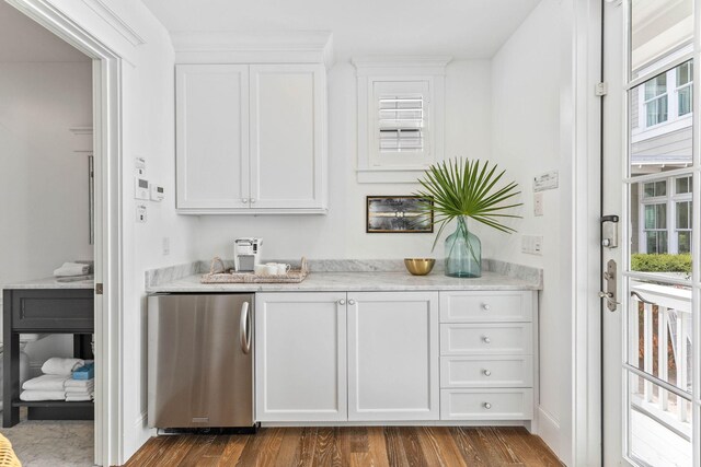 bar featuring white cabinets, wood-type flooring, fridge, and light stone counters