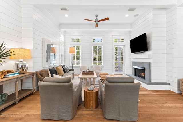 living room with ceiling fan and light wood-type flooring