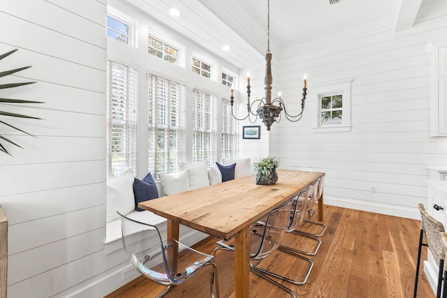 dining room with hardwood / wood-style flooring, a notable chandelier, and a wealth of natural light