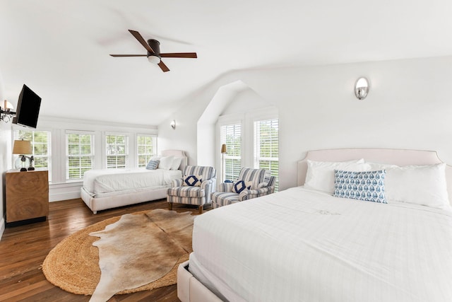 bedroom with dark wood-type flooring, ceiling fan, multiple windows, and vaulted ceiling