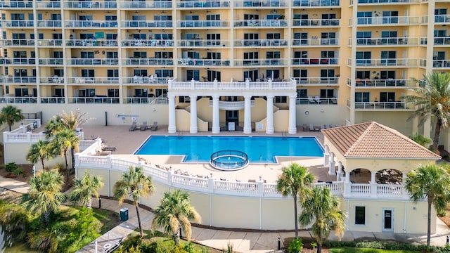 view of swimming pool with a community hot tub and a patio area