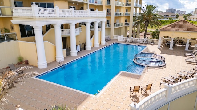 view of pool with a gazebo, a patio, and a community hot tub