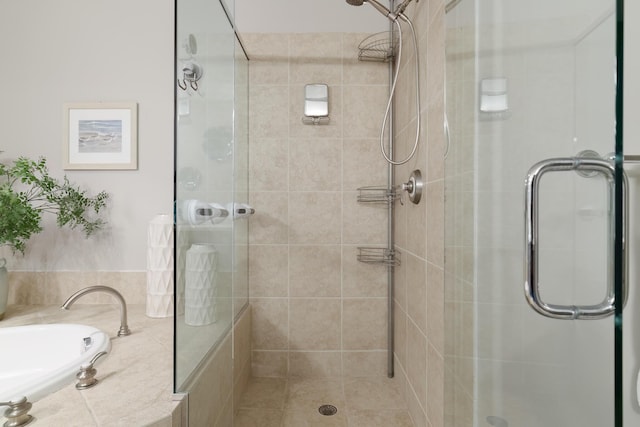 bathroom featuring a shower with door