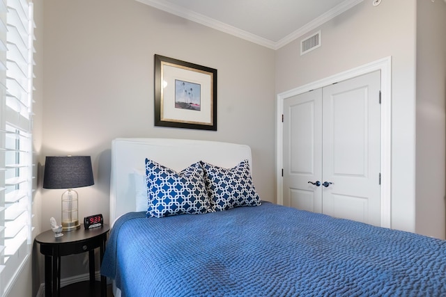 bedroom with crown molding and a closet