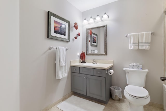 bathroom with vanity, toilet, and tile patterned flooring