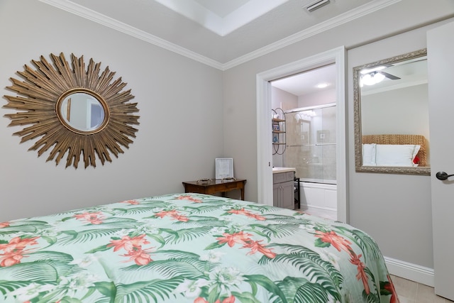 bedroom with ornamental molding and connected bathroom