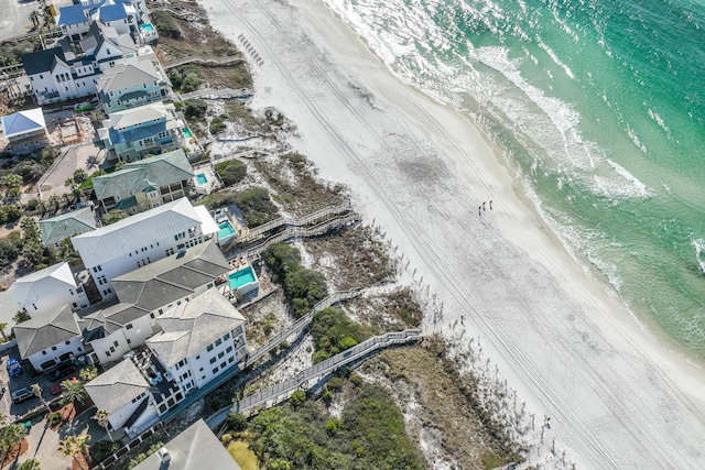 drone / aerial view featuring a water view and a view of the beach