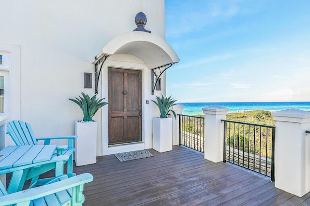 entrance to property with a water view and a beach view