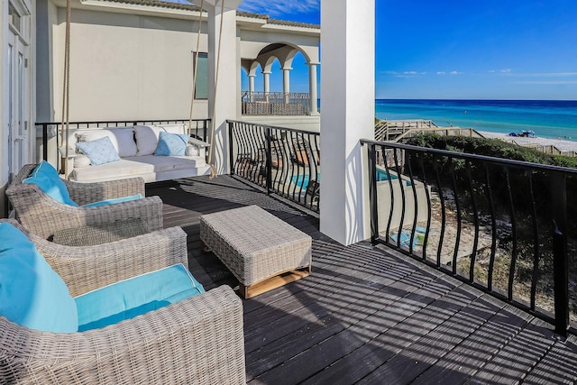 balcony with outdoor lounge area and a water view