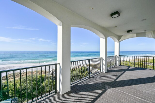 balcony featuring a water view and a beach view