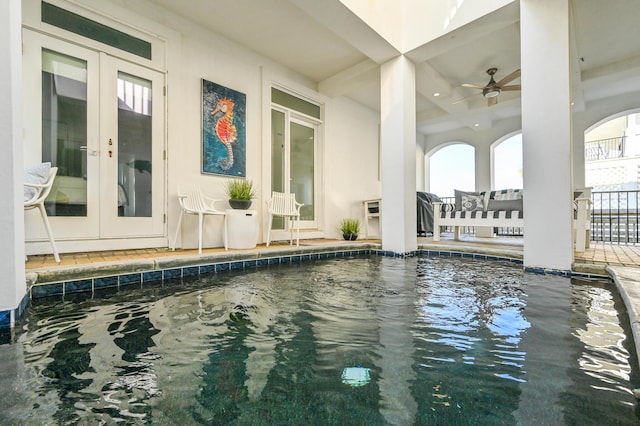 view of swimming pool featuring french doors and ceiling fan