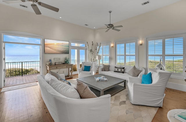 living room with light hardwood / wood-style floors and ceiling fan