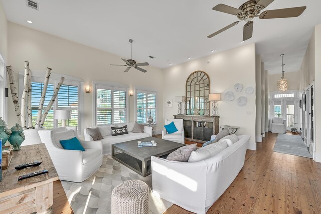 living room featuring ceiling fan and light hardwood / wood-style flooring