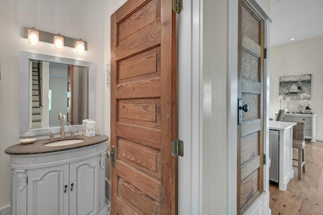 bathroom featuring vanity and wood-type flooring