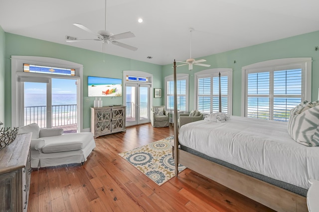 bedroom with hardwood / wood-style floors, access to exterior, and ceiling fan