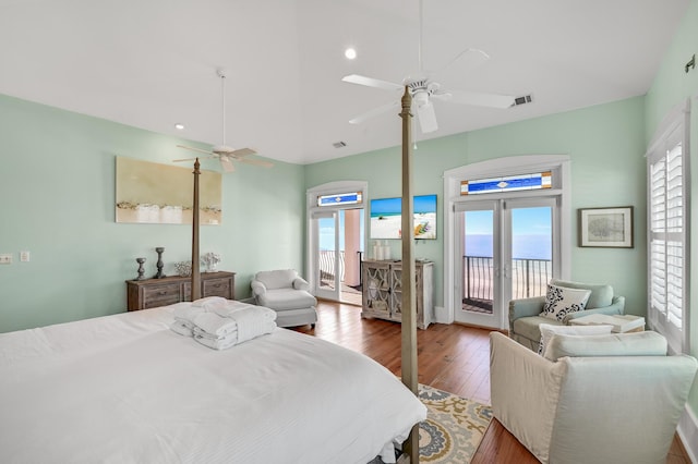 bedroom with hardwood / wood-style flooring, ceiling fan, multiple windows, and access to outside