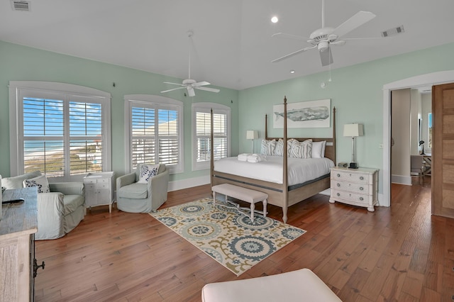 bedroom with hardwood / wood-style floors, vaulted ceiling, and ceiling fan