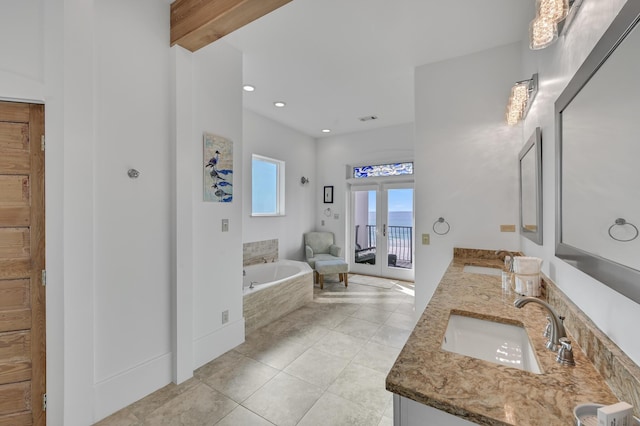 bathroom with beamed ceiling, tile patterned flooring, vanity, a relaxing tiled tub, and french doors