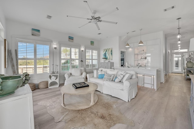 living room featuring light hardwood / wood-style floors and ceiling fan