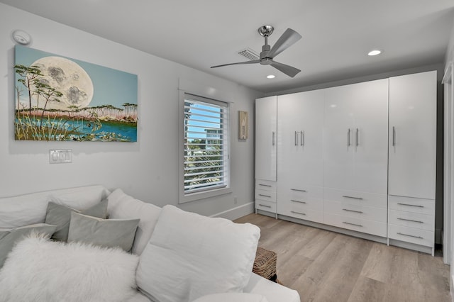 bedroom featuring light hardwood / wood-style flooring, a closet, and ceiling fan