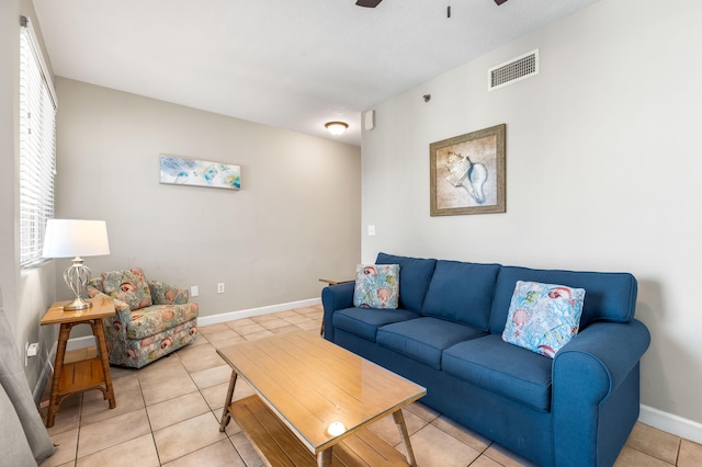 living room with light tile patterned flooring, plenty of natural light, and ceiling fan