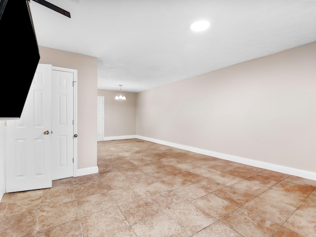 unfurnished room with an inviting chandelier and light tile patterned floors