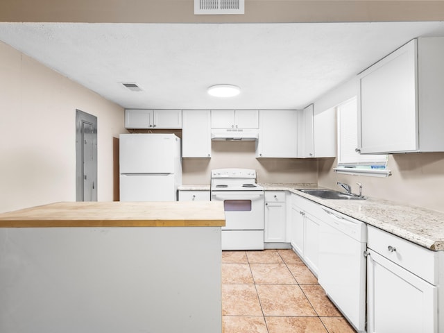 kitchen featuring butcher block countertops, white appliances, white cabinets, sink, and light tile patterned flooring