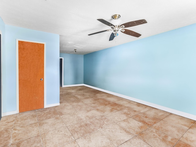 empty room featuring light tile patterned floors and ceiling fan