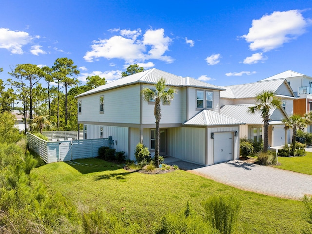 view of property with a garage and a front lawn