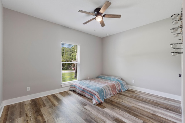 bedroom with ceiling fan and hardwood / wood-style floors