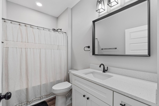 full bathroom featuring vanity, hardwood / wood-style flooring, toilet, and shower / bath combo