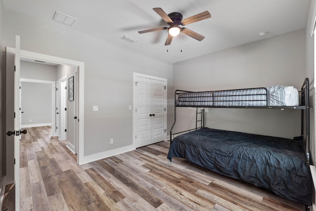 bedroom with hardwood / wood-style flooring and ceiling fan