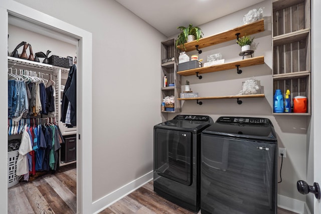 laundry room featuring dark hardwood / wood-style flooring and washing machine and dryer