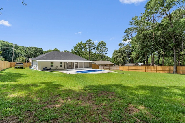 view of yard featuring a fenced in pool and a patio