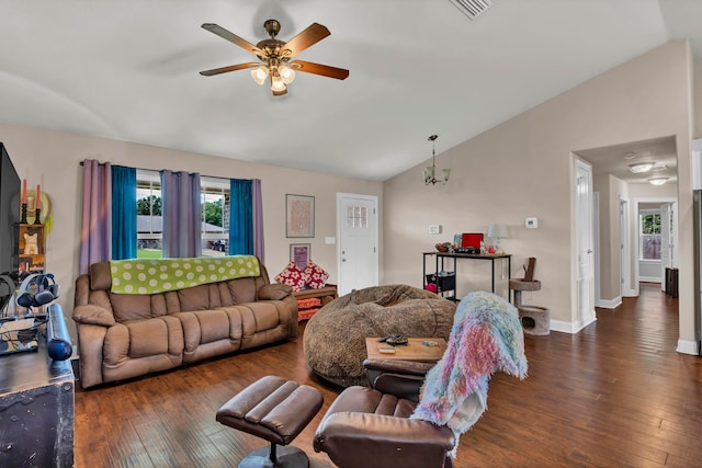 living room with dark hardwood / wood-style flooring, ceiling fan with notable chandelier, and vaulted ceiling