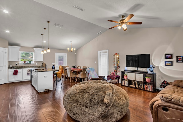 living room featuring dark hardwood / wood-style floors, ceiling fan with notable chandelier, sink, and high vaulted ceiling