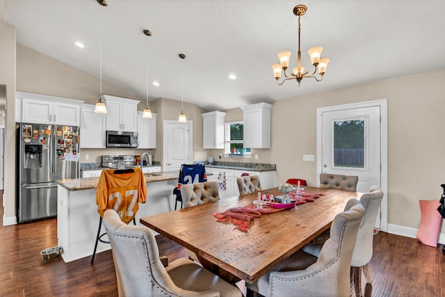 dining area featuring dark wood-type flooring, lofted ceiling, sink, and a chandelier