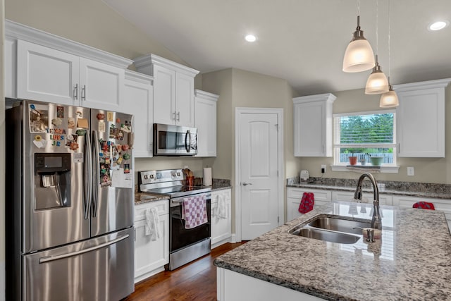 kitchen featuring appliances with stainless steel finishes, sink, lofted ceiling, white cabinetry, and dark hardwood / wood-style flooring