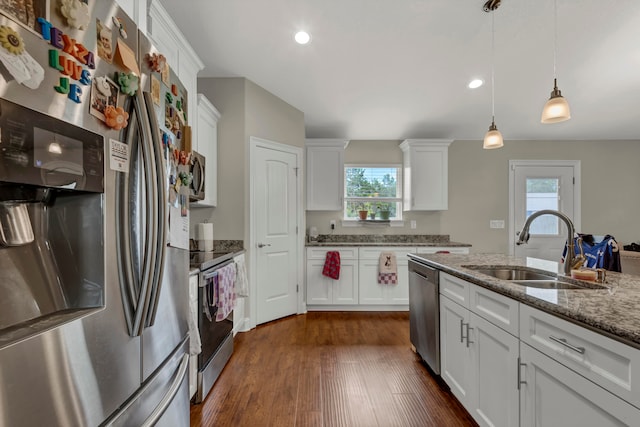 kitchen with white cabinetry, dark hardwood / wood-style floors, stainless steel appliances, light stone countertops, and sink