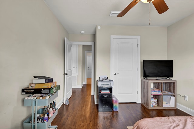 interior space with dark wood-type flooring and ceiling fan