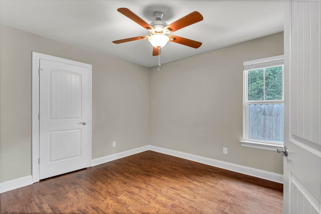 unfurnished room with ceiling fan and dark wood-type flooring