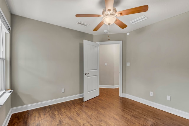 empty room with ceiling fan and hardwood / wood-style flooring