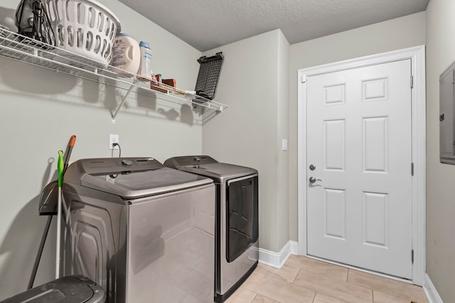 washroom with washing machine and dryer and light tile patterned floors