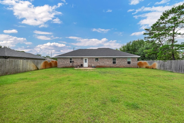 back of property featuring a lawn