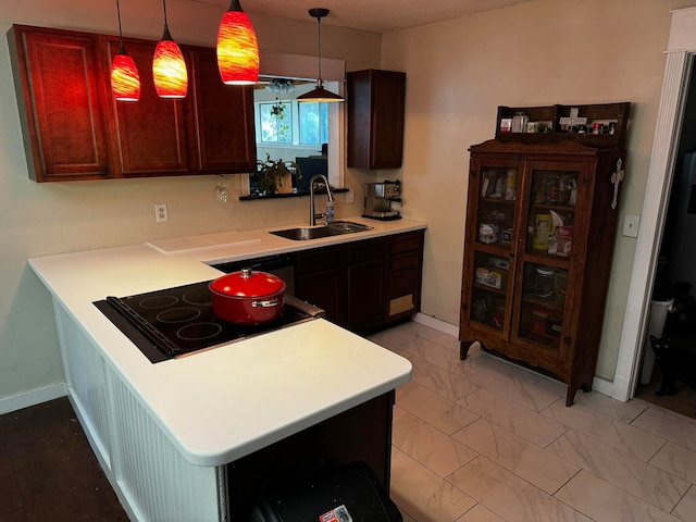 kitchen featuring sink, kitchen peninsula, hanging light fixtures, light tile patterned floors, and black electric stovetop